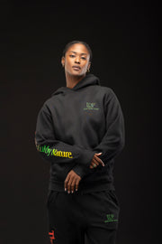 Woman wearing a black hoodie with visible branding on a dark background