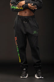 Woman wearing black sweatpants with text on a dark background