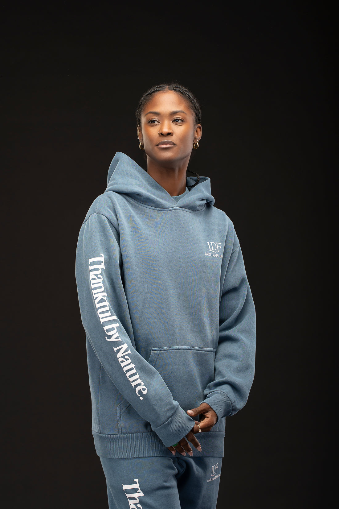 Woman wearing a blue hoodie with text on a black background