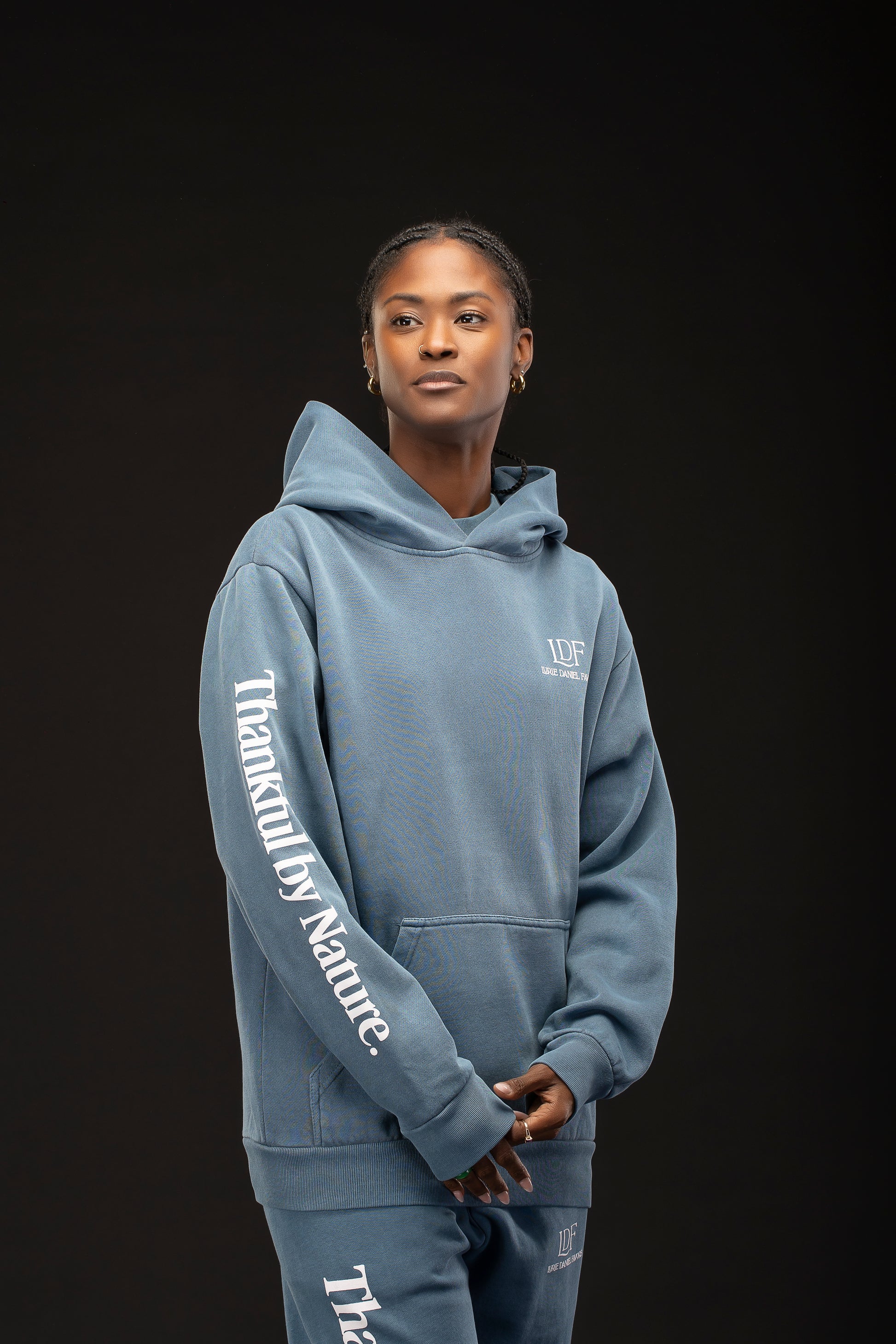 Woman wearing a blue hoodie with text on a black background